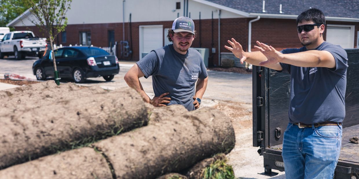 Crew of Now Mow Worries Lawn care and Landscape, LLC working on sod.