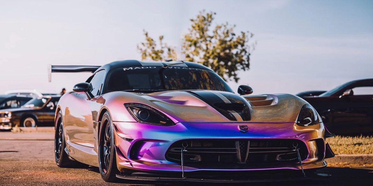 Iridescent sports car with a large rear wing.