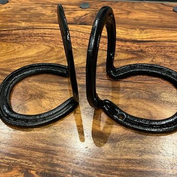 Bookends made from recycled horseshoes and painted black