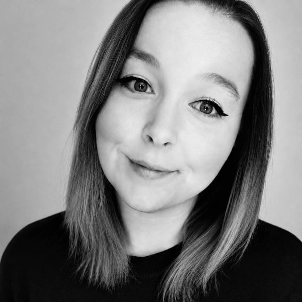 Black and white portrait of a woman smiling gently.