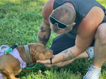 Man gently holding a dog's face in his hands.