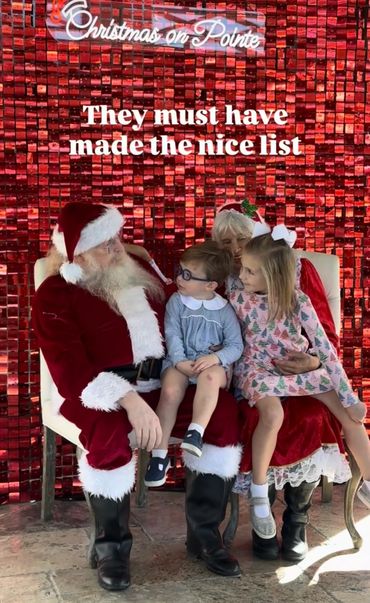 Santa and Mrs. Claus with two children during Christmas event.