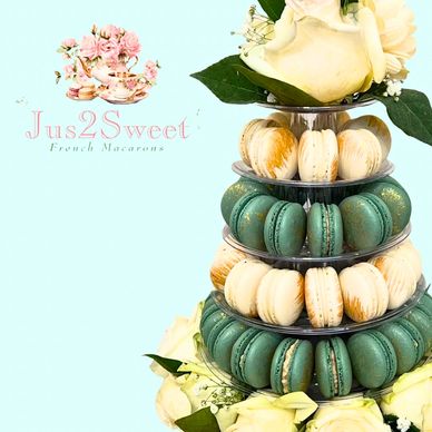 Elegant macaron tower with white roses and green leaves for Jus2Sweet.
