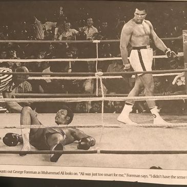 Iconic photo of Muhammad Ali standing over George Foreman in the boxing ring.