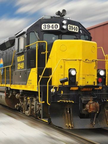 A yellow and black locomotive train numbered 3940 moving on tracks.