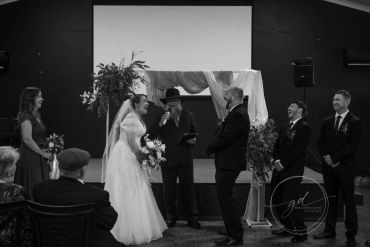 A joyful wedding ceremony with the bride and groom exchanging vows.