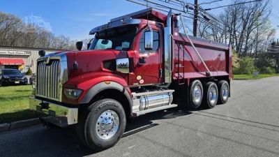 Red dump truck parked on a street.