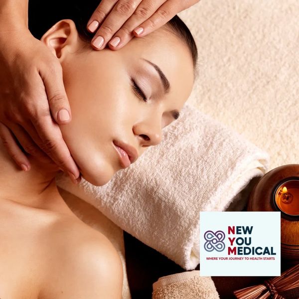 Woman receiving a relaxing facial massage in a spa setting.