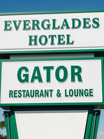 Sign for Everglades Hotel and Gator Restaurant & Lounge.