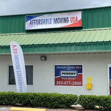 Affordable Moving USA storefront with green roof and signage.