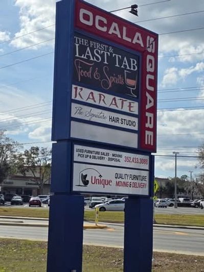 Ocala Square sign with businesses listed including a hair studio and karate.