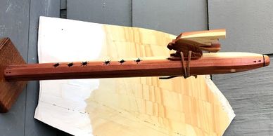 F-Sharp tone 6 hole octagon ncedar flute with an Eagle Reed. Adorned with sacred wood burned designs