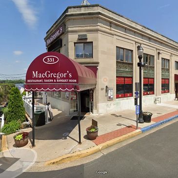 MacGregor's restaurant entrance with maroon awning on a sunny day.