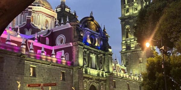 Catedral iluminada de noche con luces coloridas.