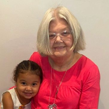 Smiling elderly woman with a young girl.