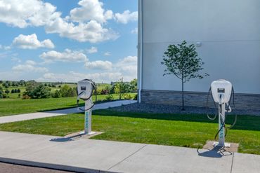 Two Siemens electric vehicle charging stations on a sunny day.