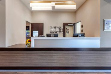 Modern hotel reception desk with clean design and bright lighting.