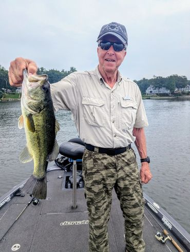 Man holding a large fish on a boat.