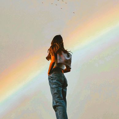 Woman with rainbow and seagulls
