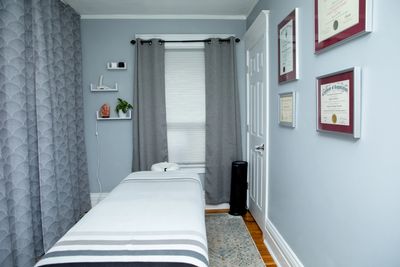 A photo of Meghan's home practice. Grey walls, diplomas, air purifier.