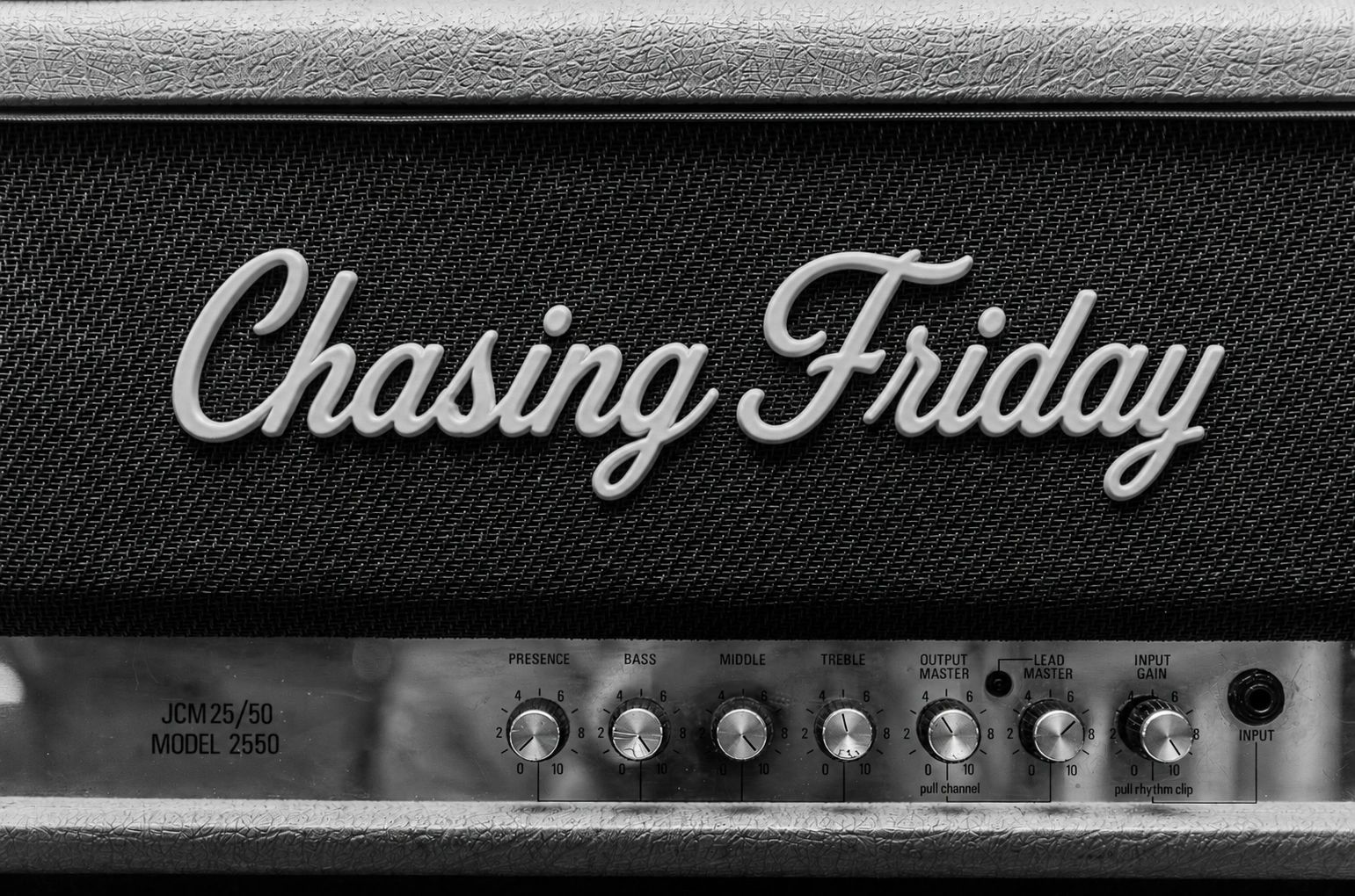 Close-up of a guitar amplifier with the name Chasing Friday.
