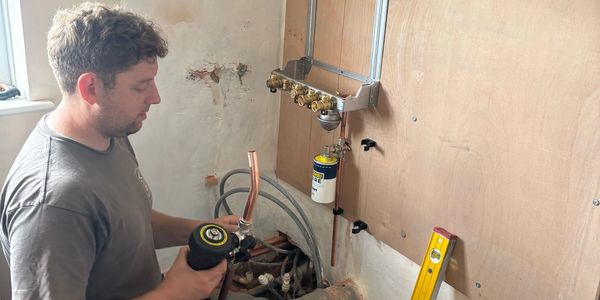 engineer fitting a gas boiler 