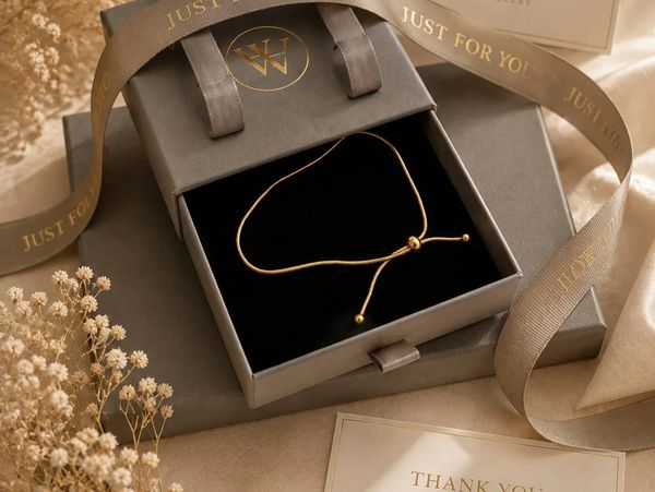 Elegant gold bracelet in a gift box with 'Just For You' ribbon.