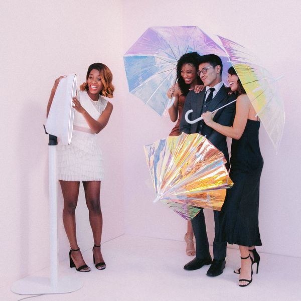 Group using Photo Booth to take picture with umbrella props.