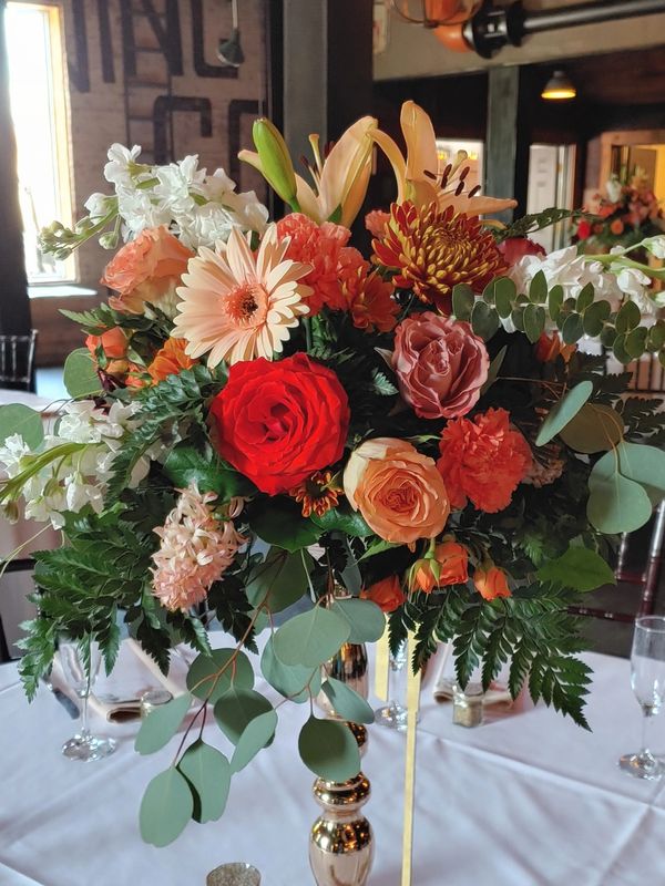 Elegant floral centerpiece with roses and greenery.