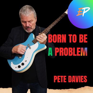 Pete Davies hold his Dan Electro guitar up and plays it