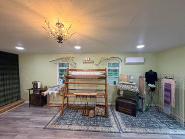 Cozy craft room with wooden loom and vintage decor.