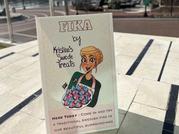 Signboard advertising Swedish Fika treats by Kristina's Swede Treats outdoors.
