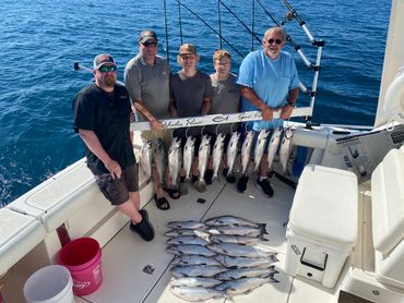 Grandfather, father and sons during Lake Michigan Charter Fishing trip for Coho Salmon