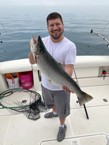 Man holding large Brown Trout caught during Lake Michigan Charter Fishing trip