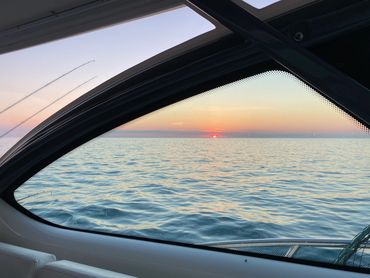 Sunrise through roof supports on 38 Tiara Open during Lake Michigan Charter Fishing Trip