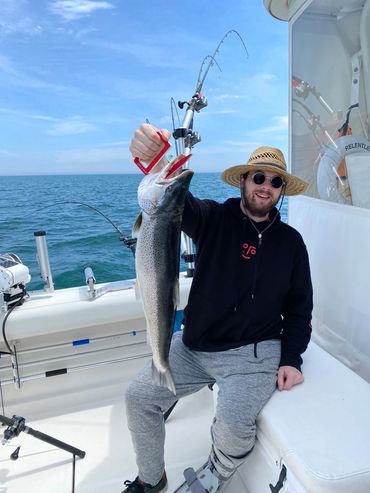 Guy celebrating his fish catch aboard Relentless Pursuit Sport Fishing