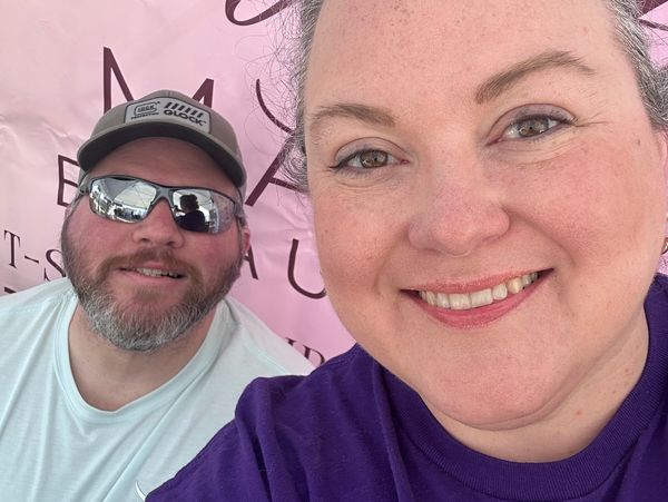 Smiling man and woman taking a selfie together.