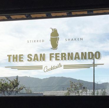 Window decal for The San Fernando Cocktails with mountains in background.