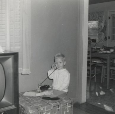 Darcy with a toy phone, 1957