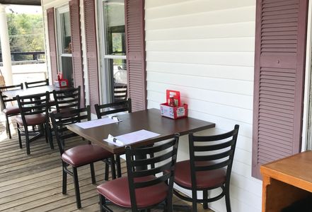 Outdoor dining area with tables and chairs.