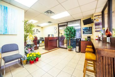 Clean office view of repair shop with tables and chair
