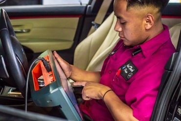 A person checking the car