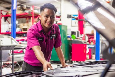 A Man in pink uniform doing repairing