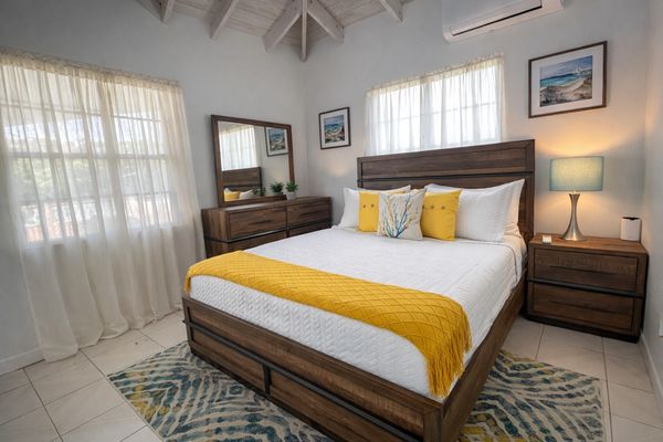 Bright bedroom with wooden furniture and yellow accents.