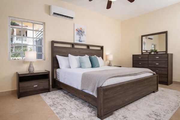 Modern bedroom with wooden furniture and soft neutral tones.