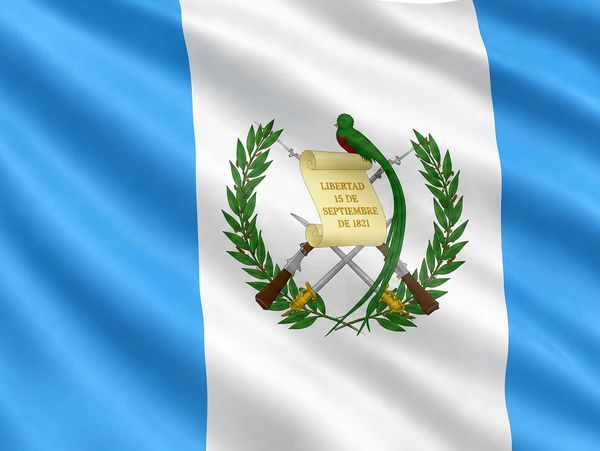 Flag of Guatemala with blue and white stripes and national emblem.