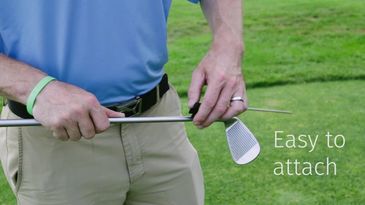 golfer attaching golf club tee to golf wedge