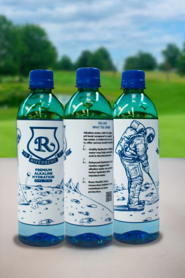 Three bottles of Riverbend premium alkaline water with a space-themed design on their labels.