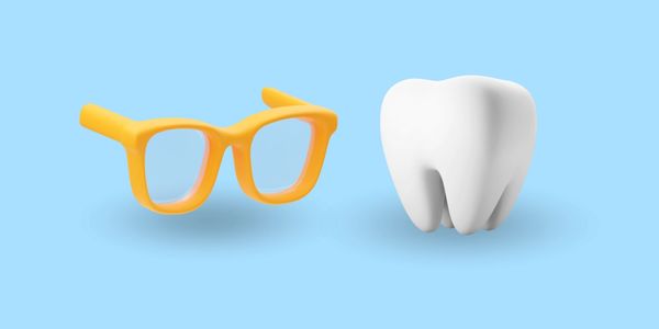 Yellow glasses and a white tooth on a blue background.
