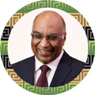 Smiling man in glasses and suit with decorative circular frame.